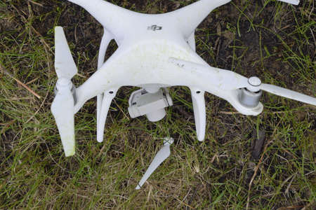Russia, Poltavskaya village - May 9, 2017: The crashed drone. Dirty and in the juice of the grass is a quadrocopter. DJI Phantom 4のeditorial素材