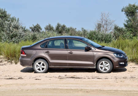 Anapa, Russia - July 17, 2017: Volkswagen Polo car on the beach in the sand against a background of vegetation.のeditorial素材