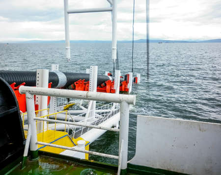 Descent of the pipeline to a bottom exhausting with the pipelaying barge. Installation of the...
