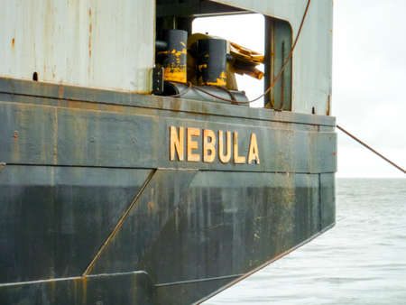 Baltic Sea, Russia - September 12, 2016: Pipework barge Nebula. Part of the vessel with the name. The cargo ship with the crane, the top view. Pipelaying bargeのeditorial素材