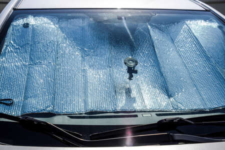 Protection of the car panel from direct sunlight. Sun Reflector windscreen.の写真素材