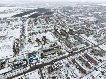 Winter view from the bird's eye view of the village. The streets are covered with snow.