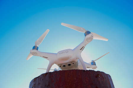 Krasnodar, Russia - June 10, 2017: Quadrocopter Phantom 4 against the blue sky in the sun. Backlight. Dron is an innovative flying robot.の写真素材