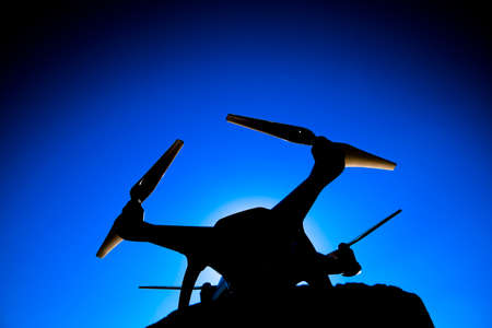 Krasnodar, Russia - June 10, 2017: Quadrocopter Phantom 4 against the blue sky in the sun. Backlight. Dron is an innovative flying robot.の写真素材