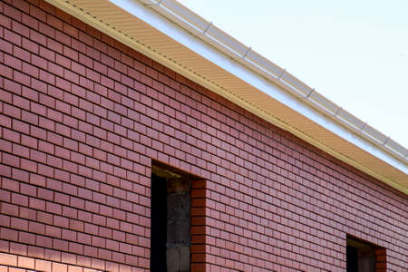 New brick house under construction. Brown and pink brickの写真素材