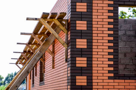 New brick house under construction. Brown and pink brickの写真素材