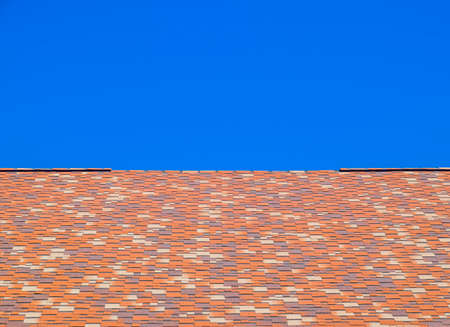 Roof from multi-colored bituminous shingles. Patterned bitumen shinglesの写真素材