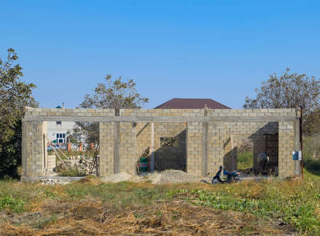 Unfinished house from a cinder block. The walls of the building under constructionの写真素材