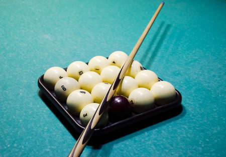 Billiards, billiard table, balls and cue. Balls in the tray and cue on the balls.の写真素材
