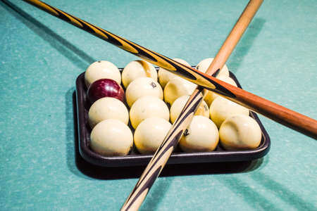 Billiards, billiard table, balls and cue. Balls in the tray and two cues on the balls.の写真素材