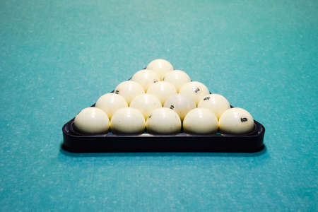 Billiards, billiard table, balls in the triangle. Construction of a pyramid of balls on a table in a poolの写真素材