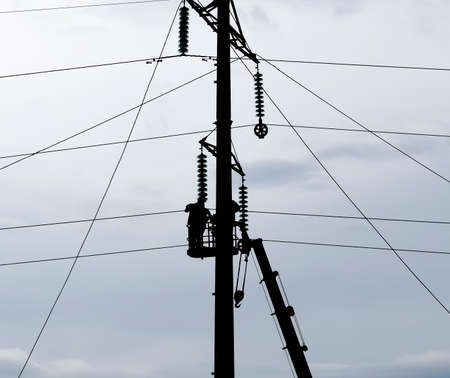 Power line support, insulators and wires. Appearance of a design. Assembly and installation of new support and wires of a power line.の写真素材
