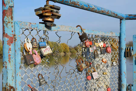 Krasnodar, Russia - November 4, 2017: Love locks hung by newlyweds and lovers on the fence near the...