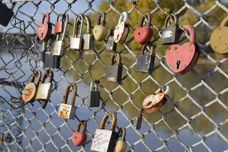 Krasnodar, Russia - November 4, 2017: Love locks hung by newlyweds and lovers on the fence near the river. A symbol of strong relationships and eternal love.のeditorial素材