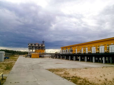 Yellow building - Oil pumping station for oil pumping. Oilfield facilities