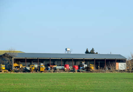Tractors and other equipment under the awning in the garageの写真素材