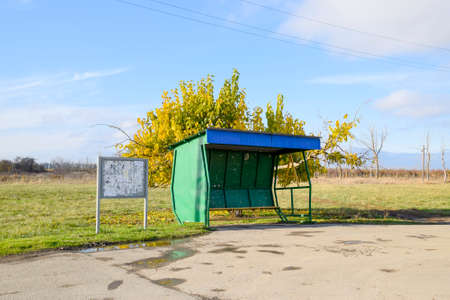 Bus stop in the village. The bus stop next to the treeの写真素材