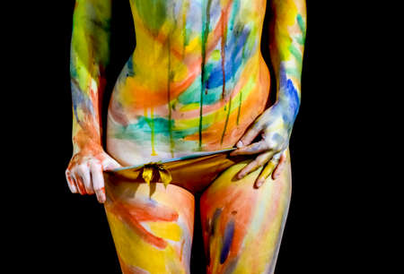 Body art. Drawing on the body. Beautiful girl with painted body watercolors. A white young girl painted the body with paint.の写真素材