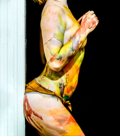 Girl with traces of the palms on the buttocks. Paint on the ass. Body art. Drawing on the body. Beautiful girl with painted body watercolors. A white young girl painted the body with paint.の写真素材