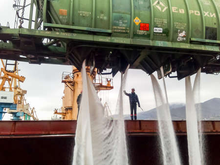 Novorossiysk, Russia - August 11, 2017: spillage of saltpeter from the car into the hold of the tanker. Loading of mineral fertilizers in the ships hold.のeditorial素材
