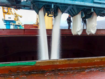 Novorossiysk, Russia - August 11, 2017: spillage of saltpeter from the car into the hold of the tanker. Loading of mineral fertilizers in the ships hold.のeditorial素材