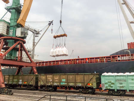 Novorossiysk, Russia - August 11, 2016: Loaded freight cars in the port. Passage of cars under the tower crane.のeditorial素材