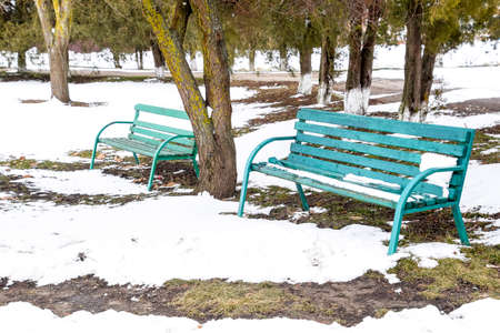 Green bench in the park in winter. Snow in the parkの写真素材