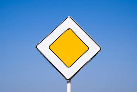 Road signs, the main road. Sign on a blue background.の写真素材