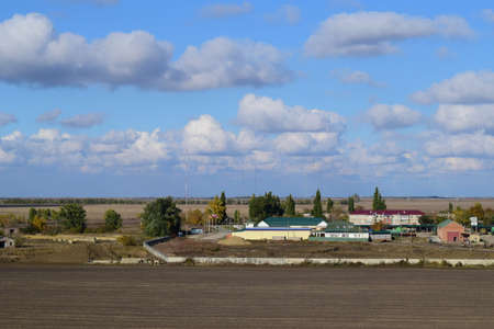 A view from above of a small Russian village. Rural landscape. Field and village. A semi-abandoned villageの写真素材