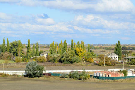 A view from above of a small Russian village. Rural landscape. Field and village. A semi-abandoned villageの写真素材