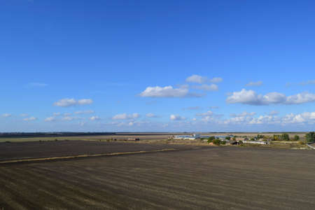 plowed field in the spring in the village. Agricultural land in the Kuban. Preparation of fields for sowing wheatの写真素材