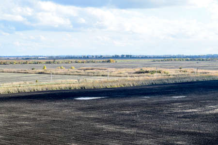 plowed field in the spring in the village. Agricultural land in the Kuban. Preparation of fields for sowing wheatの写真素材