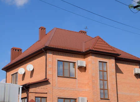 Decorative metal tile on a roof. Types of a roof of roofs. Decorative metal on the roof of the...