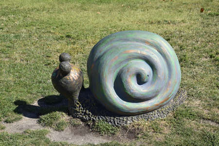 Monument to a toy snail on the lawnの写真素材