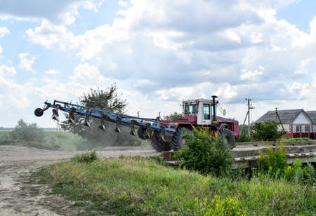 Plow on trailer for tractor. Plow for plowing soil. Trailer Hitch for tractors and combines. Trailers for agricultural machinery.の写真素材