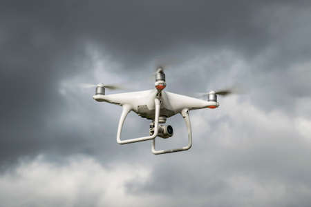 Krasnodar, Russia - May 30, 2017: Dron against the cloudy sky. The flight of the drone before a thunderstorm. Drone DJI Phantom 4 in flight. The flight of the copter in the sky.のeditorial素材