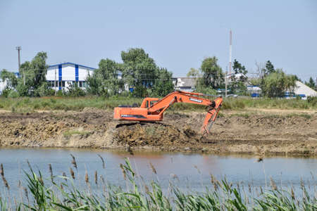 Krasnodar, Russia - June 27, 2016: Excavator digs clay in the Quarry with clay. Extraction of clay.のeditorial素材
