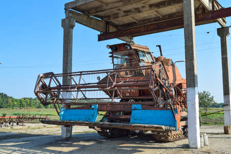 Russia, Poltavskaya village - September 6 2015: Old rusty disassembled combine harvester. Combine...