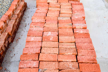 The red brick folded neatly on the foundation of the house. Home construction.の写真素材