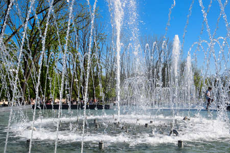 Krasnodar, Russia - May 1, 2017: City fountain in the city of Krasnodar. People are walking by the fountain. Water splashes.のeditorial素材