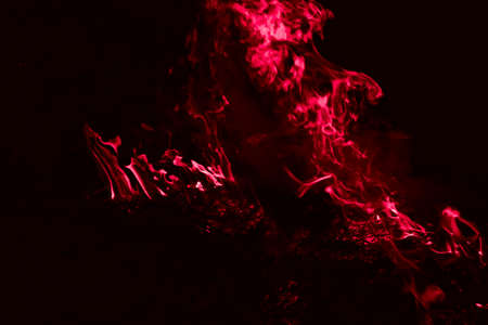 Fire. Burning of rice straw at night. A dark red flame.