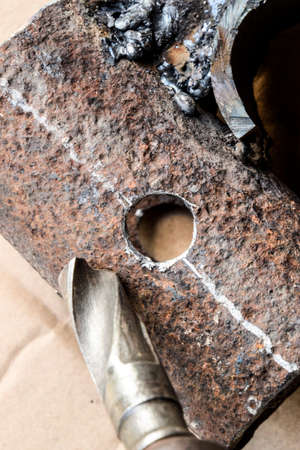 Drill for metal. A drilled hole in the steel partの写真素材