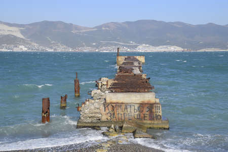 Old dismantled rusty pier. The inscription: it is forbidden to swim. The destroyed pier.の写真素材