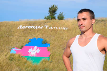 Ataman, Russia - September 26, 2015: man on the background of a hill with an inscription Legends of Taman and a tricolor of the Krasnodar Territory in the form of the territory of the Krasnodar Territory.のeditorial素材
