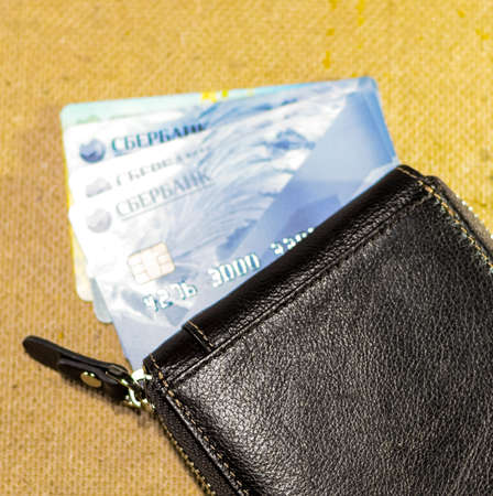 Krasnodar, Russia - March 12, 2016: Brown leather wallet with credit and discount cards.のeditorial素材