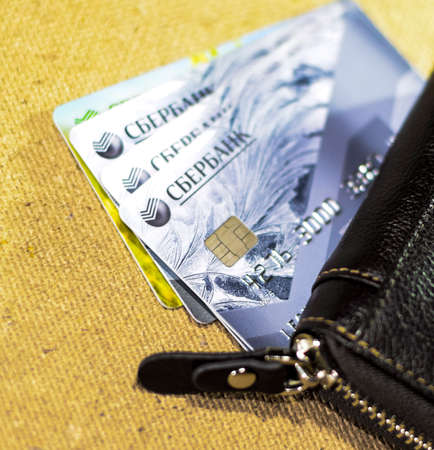 Krasnodar, Russia - March 12, 2016: Brown leather wallet with credit and discount cards.のeditorial素材