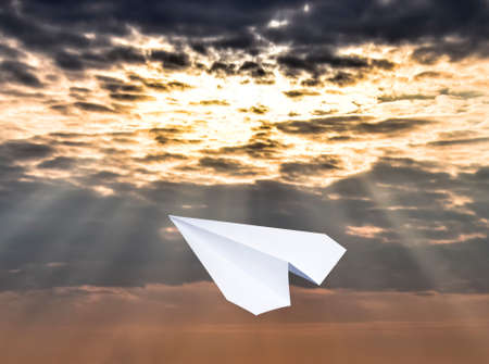 White paper airplane in a blue sky with clouds. The message symbol in the messenger.の写真素材