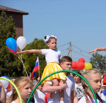 Slavyansk-on-Kuban, Russia - May 1, 2018: Young sportsmen of city sports schools. Celebrating the first of May, the day of spring and work. May Day parade on the Theater Square in the city of Slavyansk-on-Kuban.のeditorial素材