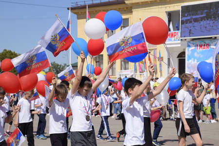 Slavyansk-on-Kuban, Russia - May 1, 2018: Young sportsmen of city sports schools. Celebrating the first of May, the day of spring and work. May Day parade on the Theater Square in the city of Slavyansk-on-Kuban.のeditorial素材