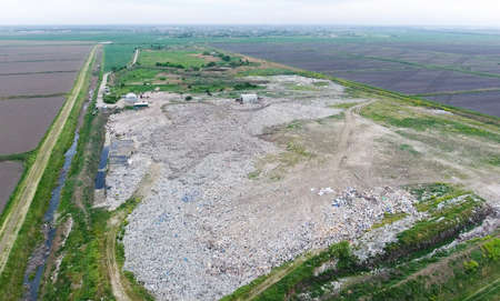 garbage dump with heaps of garbage and treatment facilities. Landfill of garbage outside the village.の写真素材
